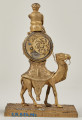 Zegar z wielbłądem z brązu złoconego. Ujęcie tylnej strony. Na wielbłądzie znajduje się puszka z mechanizmem, zaś powyżej umieszczono Beduina.
