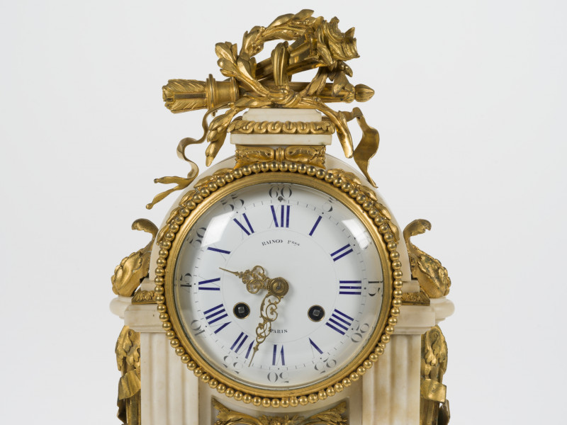 zbliżenie tarczę zegara ujętą złoconym perełkowaniem