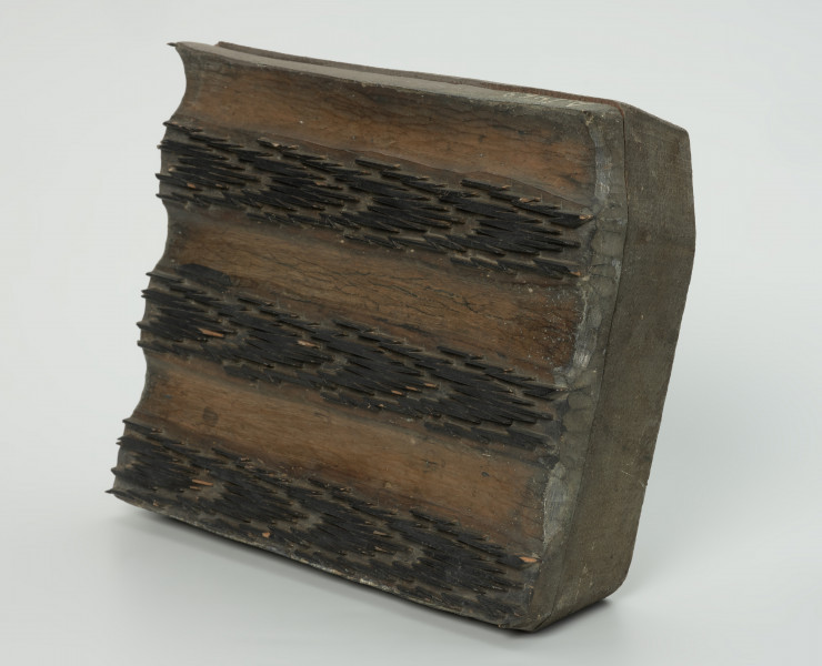 sprzęt do drukowania i grafiki, matryca drukująca - Ujęcie przodu skosem w prawą stronę. Matryca do drukowania tkanin z wykonanym w drewnie ornamentem o motywie geometrycznym.