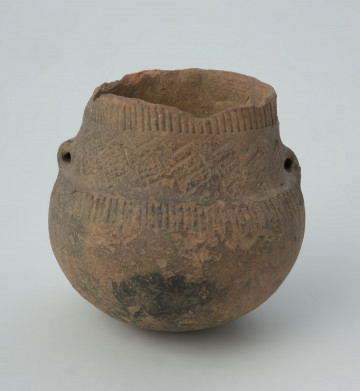 naczynie - ujęcie z przodu; Amfora z baniastym brzuścem, prawie cylindryczną szyjką i parą taśmowatych uch umieszczonych niesymetrycznie  u nasady szyjki, zdobiona pod wylewem dookolnymi pasmami pionowych słupków odciskanych, na szyjce stemplami tworzącymi zygzaki i pomiędzy nimi rytymi rombami wypełnionymi ukośną kratką, a na górze brzuśca ponownie dookolnym pasmem pionowych słupków odciskanych.