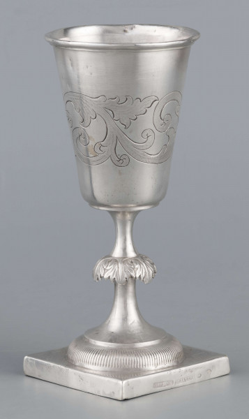 S/Mt/557/ML - Czara koniczna z brzegiem obwiedzionym wałkiem, trzon zdobiony kapturkiem z repusowanym w liście akantu, stopa okrągła z kwadratową plintą. Brzeg stopy karbowany. Na powierzchni czary grawerowany wzór stylizowanej wici roślinnej.
Na brzegu plinty sygnatury wypukłe majuskułą w prostokatnych ramkach:
- J.GAŁECKI
- w LUBLINIE
- punca owalna z przedstawieniem dłoni 
i punca okrągła z oznaczeniem próby 