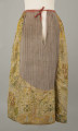 E/880/ML - Spódnica wykonana z brokatu, różnobarwna w kwiaty. Przewaga koloru złotego. Posiada lnianą podszewkę. Na przodzie wstawione lniane płótno w pasy. Noszona przez zamężne kobiety, bogate mieszczki tarnogrodzkie.