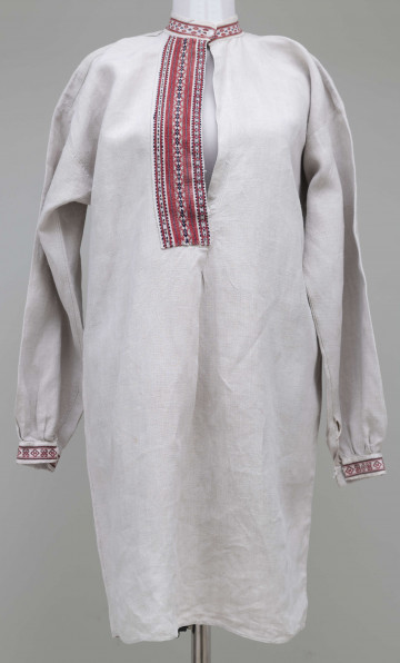 E/4655/ML - Koszula lniana z samodziałowego płótna białego, szyta na maszynie. Na kołnierzu, przodzie i mankietach zdobiona pereborami, w kolorze bordowym i granatowym. Wąski kołnierzyk.