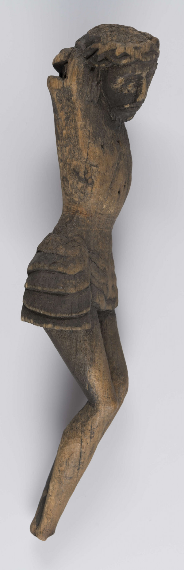 E/336/ML - Chrystus Ukrzyżowany. Stan rzeźby zły, brak rąk i stóp. Głowa lekko pochylona w prawo. Twarz o wyrazistych rysach. Na głowie korona cierniowa spleciona z wałeczków, luźno. Perizonium podkreślone łukowatymi żłobieniami. Z prawej strony płat materiału stanowiący perizonium - związany w fantazyjny węzeł. Nogi proste. Wyodrębnione uda, kolana i łydki. Stopy złączone.
