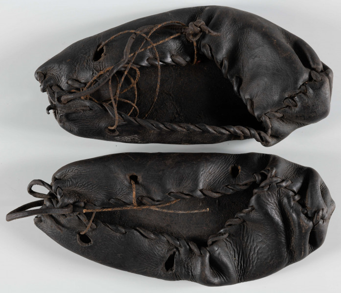 E/3028/ML - Kierpce skórzane ciemnobrązowe, z plecionką ściągającą brzeg, z otworami po bokach.