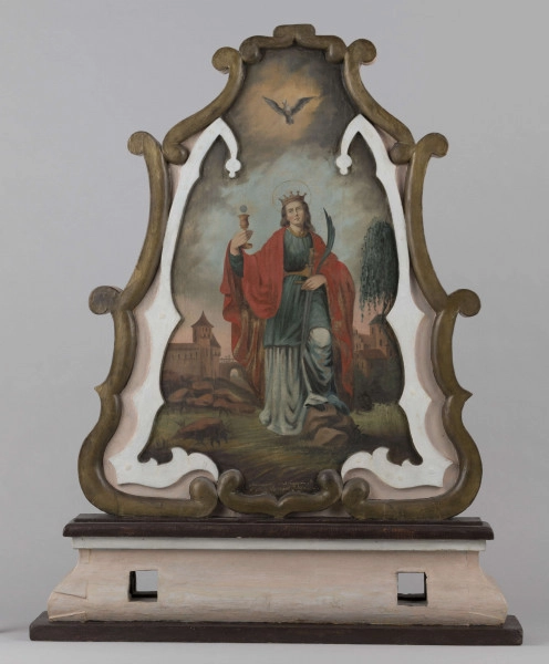 E/16800/ML - Feretron drewniany polichromowany. W obramieniu stylizowanym, przypominającym kwiat tulipana, przedstawia Św. Barbarę i Św. Onufrego. 
Św. Barbara: na tle pejzażu z  zabudową miasta (mury, wieża, most, szczyt kościoła, inne budynki), wśród kamieni i zieleni postać Świętej. Zielona szata, czerwony płaszcz na ramionach, złota korona i aureola. Lewa noga wsparta na kamieniu; w prawej uniesionej ręce kielich z hostią, w lewej opuszczonej – miecz i palma męczeństwa. Włosy długie brązowe, spływające falami na plecy. Oczy wzniesione ku niebu. Na szaro-niebieskim niebie, nad postacią, szaro-biały gołąb.
 Św. Onufry: po prawej stronie obrazu, pod drzewem, klęcząca postać Świętego (w profilu), naga, z długimi siwymi włosami i brodą. Wzrok skierowany ku postaci aniołka na obłoku (w lewym górnym rogu), udzielającemu Świętemu komunii. Aniołek z przerzuconym różowym płaszczem, w lewej ręce trzyma kielich, w prawej – hostię. Na drugim planie – bryła kościoła i krzyż przydrożny.
Napisy: patrz poniżej

Konserwacja: 1999-2000