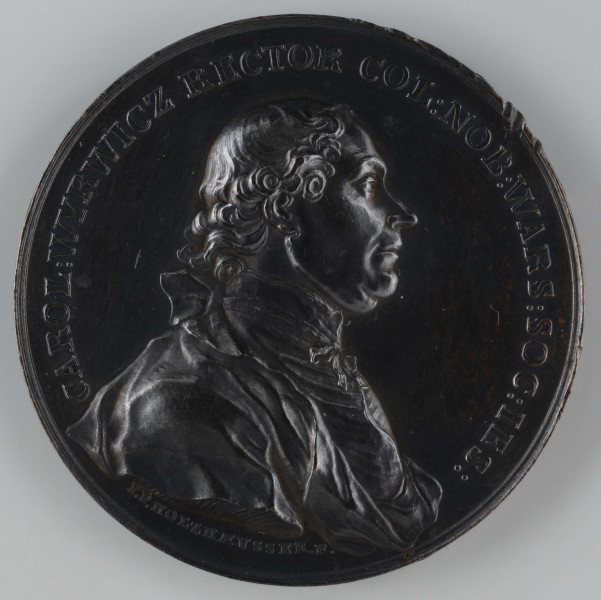 N/2564/ML - AV. Popiersie Karola Wyrwicza w profilu w prawo, z odkrytą głową. W otoku napis rozdzielony na dole przez kompozycję:
CAROL:WYRWICZ RECTOR COL:NOB:WARS:SOC:IES:
Sygnatura: I.P.HOLZHAEUSSER.F.

RV. Siedmiowierszowy napis:
IUVENTUTIS / INSTITUTIONE / SCRIPTIS QUE / DE PATRIA ET LITTERIS / BENE MERENTI / STAN:AUG:REX / MDCCLXXII
Całość ujęta otokiem z perełek o dwóch wielkościach.