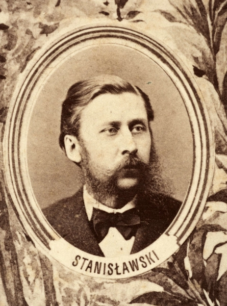 Fotografie w odcieniu sepii umieszczone na tle drzew i roślin, w centralnym miejscu postać kobiety ze sztandarem i aniołkami, wkomponowane widoki budowanej stacji, mostu kolejowego i lokomotywy. Największe zdjęcie w górnej, środkowej części bez podpisu, prawdopodobnie inż. głównej kolei nadwiślańskiej Tadeusz Chrzanowski lub jego następca Walery Titkow. Wśród podobizn pracownicy Biura Głównego Inżyniera: inż. Włodzimierz Stanisławski - pomocnik głównego inżyniera; inż. Feliks Kucharzewski -  pomocnik naczelnika biura; Feliks Kamocki - naczelnik kancelarii; Witold Lanci - naczelnik Wydz. Architektury; dr Wacław Lasocki- służba zdrowia; Władysław Radwan - sprawy zakupu gruntów; inż. Stanisław hr Scipio - projektant mostów kolejowych i jego współpracownicy: inż. Stefan Zieliński, inż. Maurycy Machalski, inż. Feliks Kucharzewski. Fotografia w passe - partout, za szkłem, oprawiona w drewnianą, profilowaną ramę.