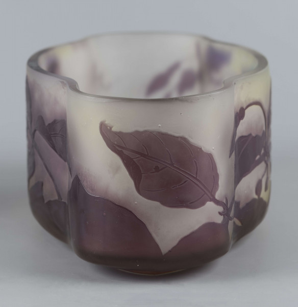 S/CS/1385/ML - Żardiniera ze szkła grubościennego, bezbarwnego, matowanego, podbarwianego żółtym i liliowym pudrem; na niskiej spiczasto-owalnej podstawie korpus o ściankach pionowo sfalowanych, u dołu lekko zaokrąglony, górna krawędź ścięta. Korpus pokryty warstwą liliową, w niej trawiony wzór roslinny: gałązka fuksji z kwiatami, przy dnie dookoła  pasmo liliowe o nieregularnym wykroju.
 