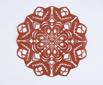Wycinanka kolista z glansowanego papieru w kolorze jasnobrązowym, o czterech osiach symetrii. W centrum wycięcia w postaci serc, na otoku w postaci owalnych listków.