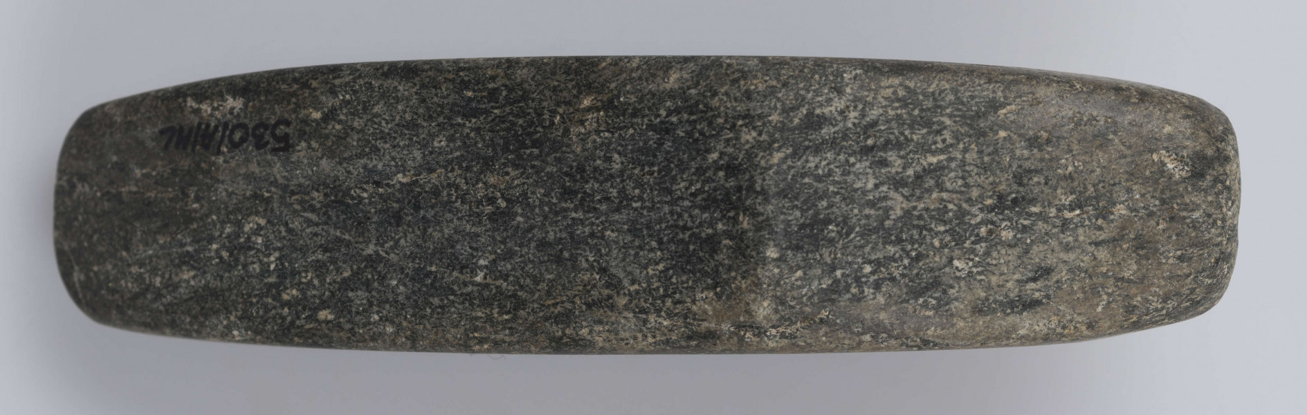 530/A/ML - Topór kamienny wykonany z czarnego kamienia, starannie gładzony. Kształt dwustożkowaty, przekrój czworokątny. Barwa czarna.
wymiary dodatkowe: 1,8 cm (średn. otworu)