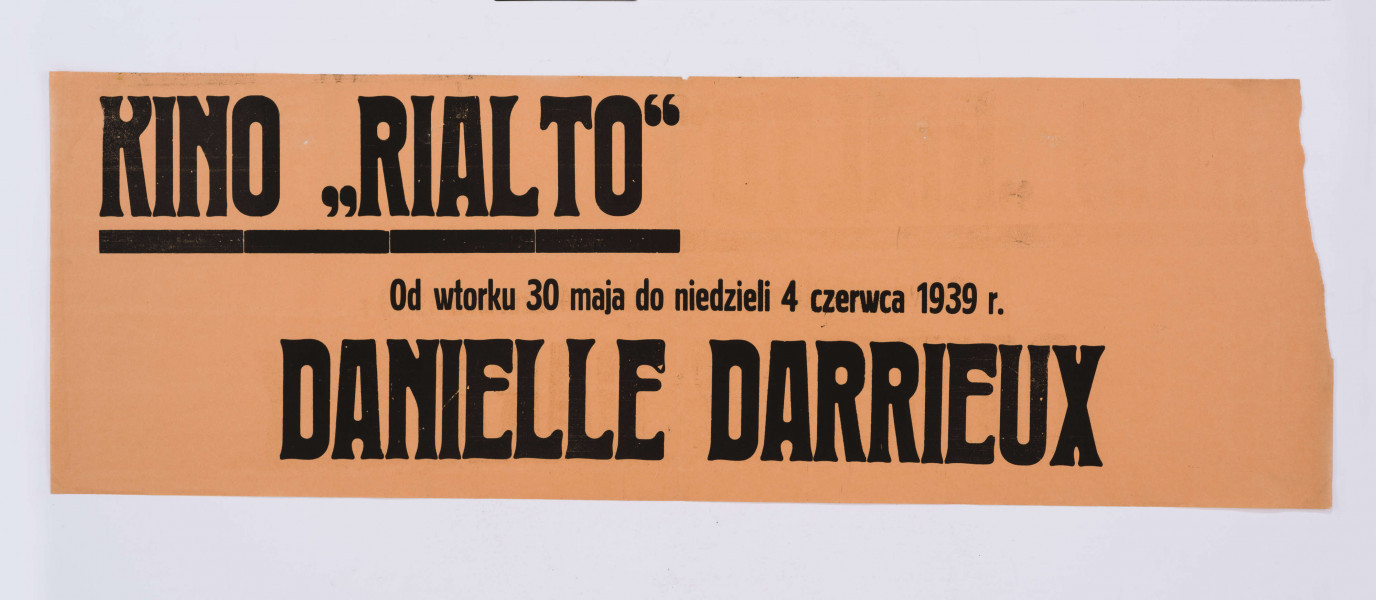 Na pomarańczowym papierze w podłużnym, poziomym formacie druk. Kino 