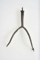Ostroga żelazna w kształcie wideł z półkoliście wygiętymi ramionami zakaończonymi gwiazdkami; kolec również zakończony gwiazdką umocowaną przez włożenie jej w rozszczepiony kolec i przewleczono nitem