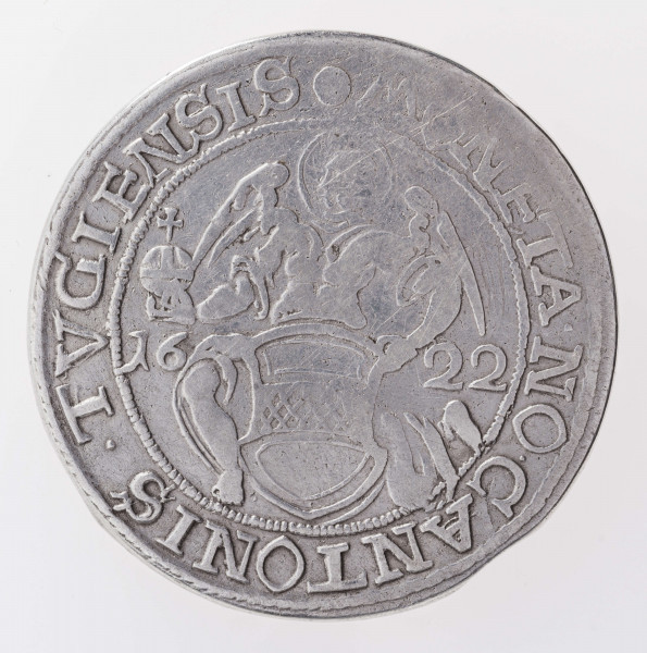 Aw. W tondzie ujętym pojedynczym otokiem nieliniowym archanioł Michał trzyma w prawej ręce jabłko panowania, lewą przytrzymuje tarczę z herbem kantonu Zug. Postać anioła dzieli datę: 16 – 22; umieszczoną na osi poziomej. Legenda otokowa:
• MONETA.NO.CANTONIS.TVGIENSIS
Na zewnątrz przy obrzeżu pojedynczy otok sznureczkowy.

Rw. W tondzie ujętym pojedynczym otokiem nieliniowym ukoronowany, dwugłowy Orzeł. Korona wychodzi poza otok i rozdziela u góry legendę:
CVM.HIS.QVI.OD.ERAT.PACE.ERAM.PACI
Przy obrzeżu pojedynczy otok .