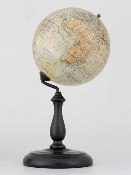 Globus fizyczno-polityczny Ziemi w skali 1:80 mln, litografia kolorowa; 12 segmentów, z polską nomenklaturą; południk zerowy biegnie przez Greenwich. Kula tekturowa, postument drewniany toczony, ramię metalowe, bez południka. Na globusie obie Ameryki, Azję i Australię otoczono czerwoną wstęgą, Afrykę - niebieską, Europa - zielono-żółtą. 