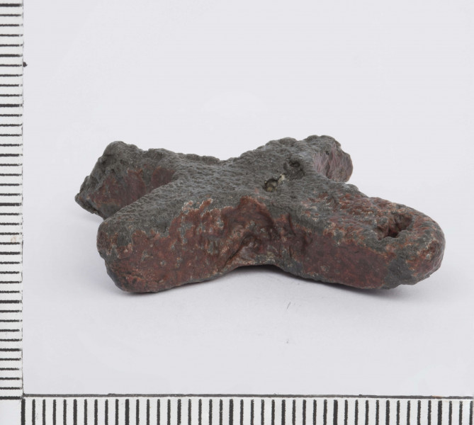 Jedno z ramion krzyża posiada okrągły otworek