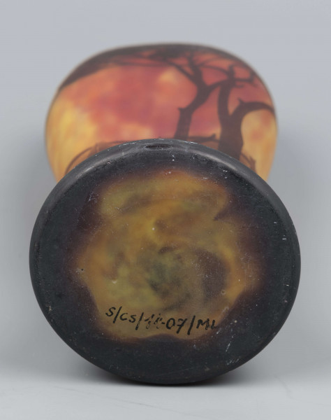 S/CS/1407/ML - Wazon o opływowym kształacie; stopa ciemnobrązowa, pogrubiona, kolista, korpus owoidalny, przewężony u dołu, dwustronnie spłaszczony. Szkło bezbarwne, powlekane, trawione, matowane i barwione pudrem szklanym, kolory: odcienie czerwieni, żółcieni i brązu. Pokryty dekoracją reliefową: krajobraz z rzeką i łódkami, na pierwszym planie wysokie drzewa, których splątane korony otaczają wylew, na stopie drobna roślinność.
W dolnej części pośród dekoracji wypukła trawiona sygnatura o dekoracyjnej formie: 
- Daum / Nancy - umieszczone jedno nad drugim i krzyż Lotryngii utworzony z linii przebiegającej przez pierwsze litery