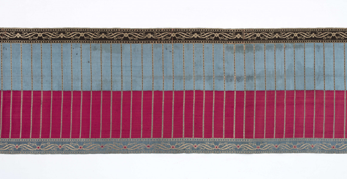 Pas kontuszowy 4-stronny
Ornament:
głowy - dwa krzaczki kwiatowe otoczone medalionami z wijącej się wstęgi
środek ( wciąż)- poprzeczne gładkie pólka
obwódki - z motywem kostki i rombów
obrzeżenia pionowe z motywem podwójnej przeplatającej się wici roślinnej, poziome - z motywem wijacej sie wstążki z kwiatami
Kolor:
pr. - tło głów i obrzeżeń srebrne, ornament brązowy z błękitem i amarantem, pólka w połowie brązowe (czarne ?), w połowie kremowe
l. - tło połowy głów i obrzeżeń błękitne oraz  w połowie pólek amarantowe, druga połowa głów i obrzeżeń brązowa oraz pólek - amarantowa
W narożnikach sygnatura wytkana 