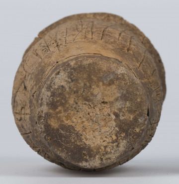 409/A/ML/2 - Naczynie esowate dno płaskie wyraźnie oddzielone brzusiec workowaty szyjka rozchylona pow zewnetrzna przy dnie i wylewie gładzona reszta obmazywana na brzuścu wykonano ostrym narzedziem nieregularne pionowe kreski