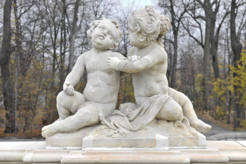 ujęcie od strony pierwszej. Nadzy i pulchni chłopiec i dziewczyna siedzą na rozpostartej ma pniu draperii. Po prawej stronie dziewczynka usiłuje objąć lewą ręką chłopca, który odpycha lewą ręką jej ramię. Twarz dziewczynki ujęta profilem. 