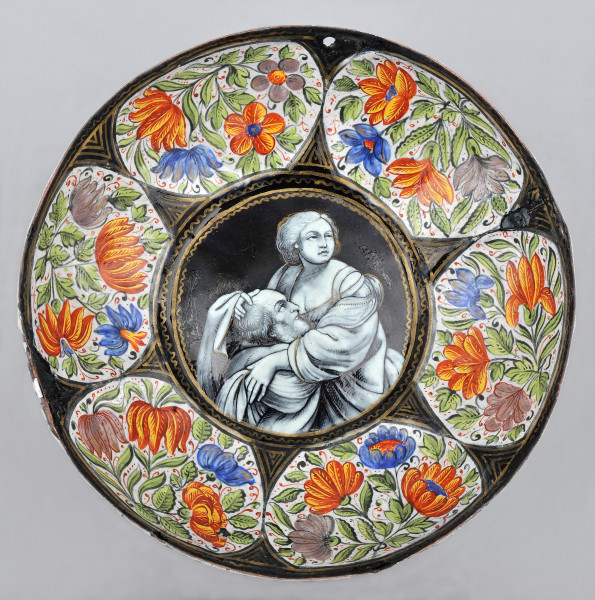 wewnętrzna strona czarki, okrągła z sześcioma wgłębieniami bogato zdobionymi kwiatami, dno okrągłe otoczone złotą zdobiną ramką wewnątrz scena Caritas Romana.