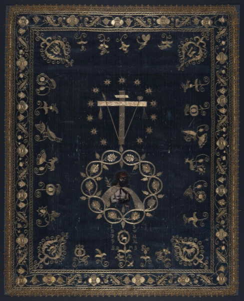 Tkanina liturgiczna, antymis (?), gremiał(?), prawdopodobnie używana w czasie postu.
Tkanina w kształcie prostokata z haftem złoconą, srebrną nicią na granatowym tle jedwabnej tkaniny. Haft linearny wzór ornamentu symetryczny względem osi  pionowj i poziomej. Na osi pionowej, w polu środkowym przedstawione są dwa medaliony.
Górny: arma christi- krzyż z opartymi o ramiona krzyża włócznią i gąbką na brzegach zawieszone są bicze( flagellum) i rózgi ( ferula). Dookoła znajduje sie trzynaście ośmioramiennych gwiazd. Dolny medalion utworzony jest z wyhaftowanej wici roślinnej w środku widnieje namalowana półpostać Chrystusa w typie Ecce Homo w koronie cierniowej na głowie w haftowanym płaszczu z trzciną w ręku. W narożnikach pola środkowego cztery herby; lewy górny narożnik herb Lubicz-podkowa, 
prawy górny narożnik herb Topór,
lewy, dolny narożnik herb Dołęga- podkowa- nad nią krzyż,
prawy dolny narożnik herb niezidentyfikowany przedstawiający baranka, kozła lub jelenia. Tkanina otoczona jest bordiurą z ornamentem roślinnym rozetkami liścmi i drobnymi kwiatkami. Tkanina obszyta dookoła złota koronką klockową.
 