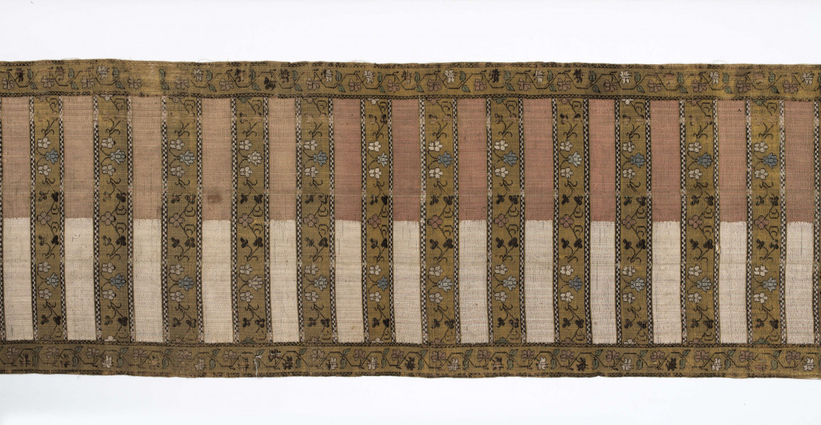 Pas kontuszowy czterostronny.
Ornament:
głowy- dwa motywy ukwiecinych łodyg umieszczonych w wazonach przypominajacych palmety- stylizowane , silna geometryzacja motywów. 
wciąż pasa- poprzeczne pólka z motywem wici kwiatowej i rzuty rozetek, na przemian
obrzeżenia- pionowe z motywem zgeometryzowanej wici kwiatowej poziome- jak w  pólkach 
kolor:pr. -  tło głów i pólek z wicią i obrzeżeń  żółte gładkie pólka w połowie różowe  w połowie różowe, wić brązowa kwiaty niebieskie, łososiowe i żółte
l. tło brązowe wzór słomkowy
Frendzla doszyta słomkowa.
