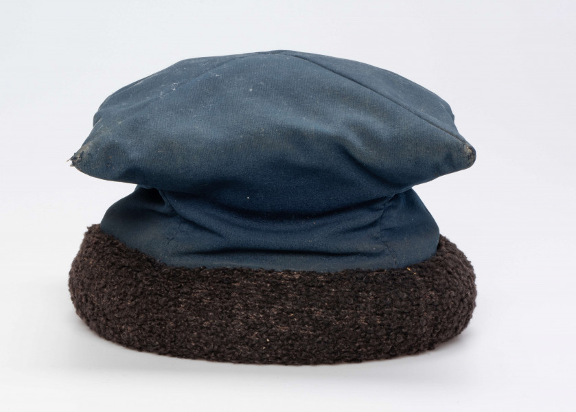 E/192/MRK/ML - Czapka rogatywka. Koloru niebieskiego z czarnym otokiem. Długość po przekątnej 30 cm. Szerokośc otoku 6,5 cm.