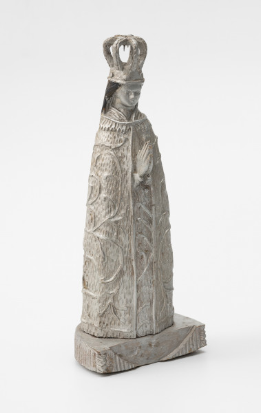 Matka Boska Skępska - ujęcie ze skosu z lewej od przodu; Rzeźba przedstawiająca figurę Matki Boskiej znajdującej się w kościele Zwiastowania Najświętszej Maryi Panny, w klasztorze ojców Bernardynów w miejscowości Skępe (województwo kujawsko-pomorskie). Postać kobieca wykonana w jednym kawałku drewna stoi na postumencie o kształcie półkola. Oba elementy połączone są ze sobą w sposób niewidoczny, prawdopodobnie za pomocą bolca lub kleju. Na frontowym boku postumentu wycięty negatyw półksiężyca. Prawdopodobnie pierwotnie w tym miejscu umieszczony był siep półksiężyca. Rzeźba pełna, wolnostojąca, statyczna, pomalowana w całości srebrną farbą – poza czarnymi włosami. Na głowie postaci duża ażurowa korona, włosy luźno spływają na plecy. Dłonie o wydłużonych palcach modlitewnie złożone na piersiach są jedyną częścią ciała widoczną poza okrywającą całą postać szatą zdobioną motywem roślinnym.