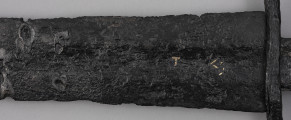miecz typu XIVa J2 (Oakeschott) - detal; Miecz długi półtoraręczny. . Powierzchnia z wżerami pokorozyjnymi. Typ wg Oakeschotta: XIVa J2 (ewentualnie XIIIa).
