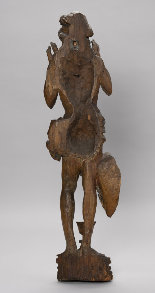 figura ołtarzowa - Ujęcie z tyłu; Figura Chrystusa stojącego tyłem na cokole. Szczupłe ciało Chrystusa o poprawnie oddanych szczegółach anatomicznych. Dłonie uniesione przy twarzy wnętrzami do widza. Na wysokim wielobocznym cokole o profilowanych ściankach, przed Chrystusem ustawiony jest kielich z wydatnym nodusem. Rzeźba przyścienna.